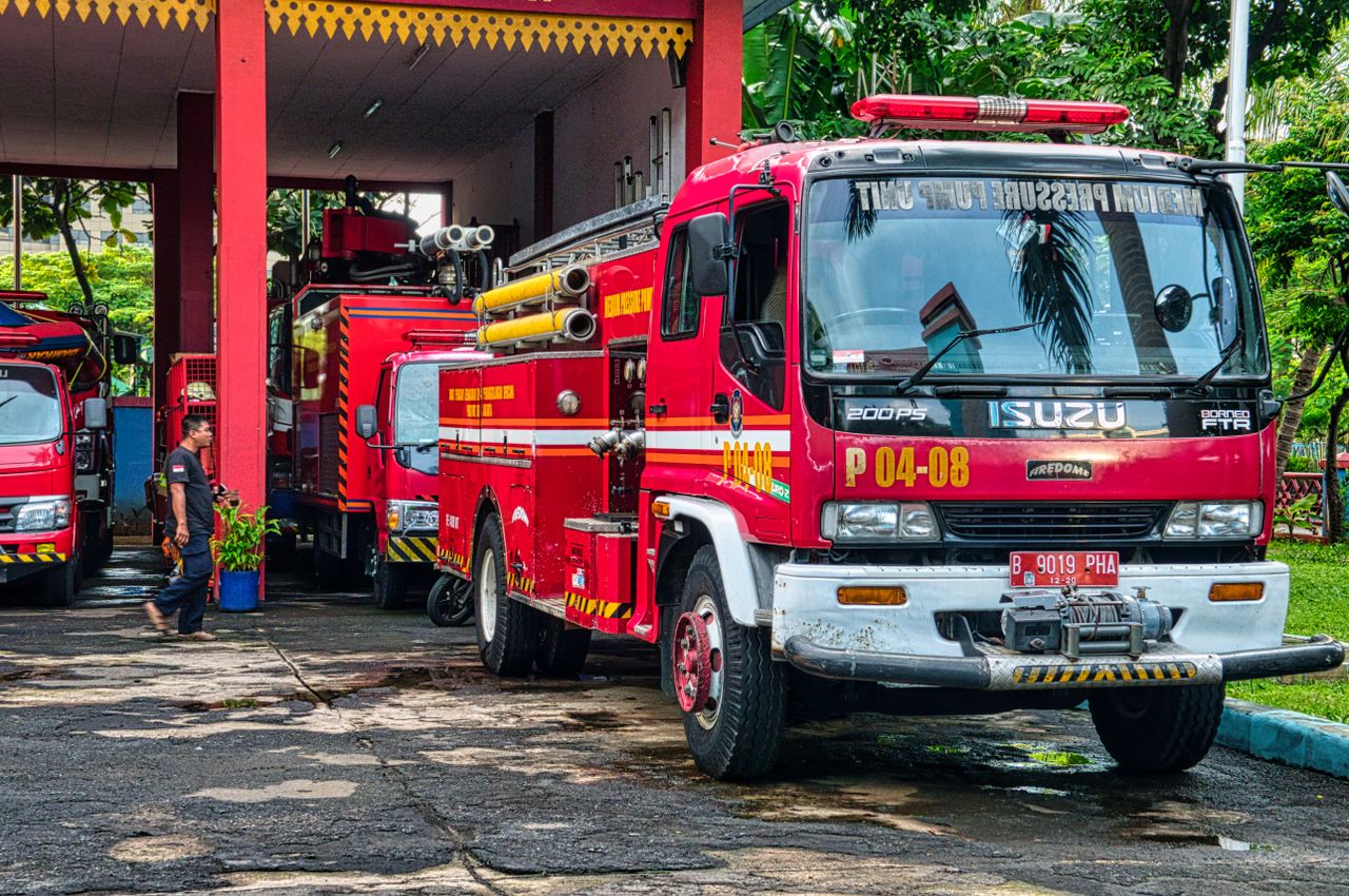 gallery-4 Fire trucks parked at an outdoor fire station in Jakarta, Indonesia during the day.
